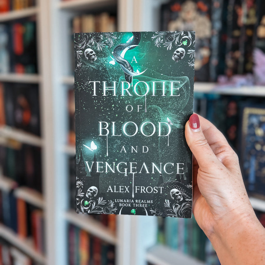 Book titled 'A Throne of Blood and Vengeance' by Alex Frost held in front of a bookshelf.