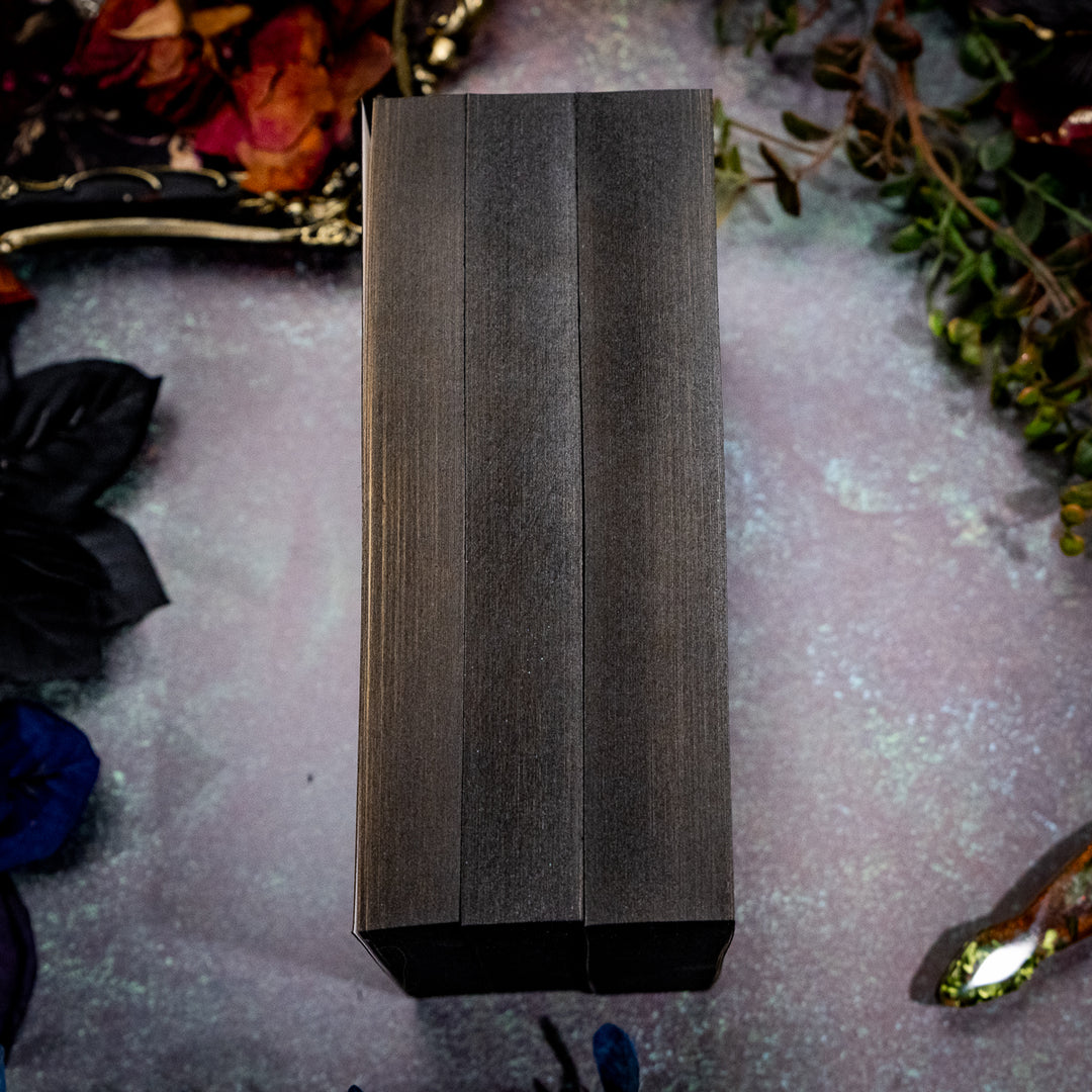 Books with black edges on table