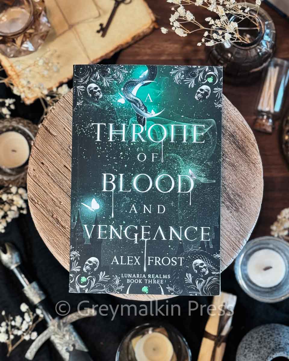 Book titled 'A Throne of Blood and Vengeance' by Alex Frost on a dark background with decorative elements.