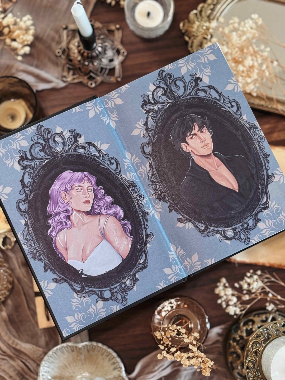 Fantasy romance book with illustrations of two people in ornate frames on a decorative surface.